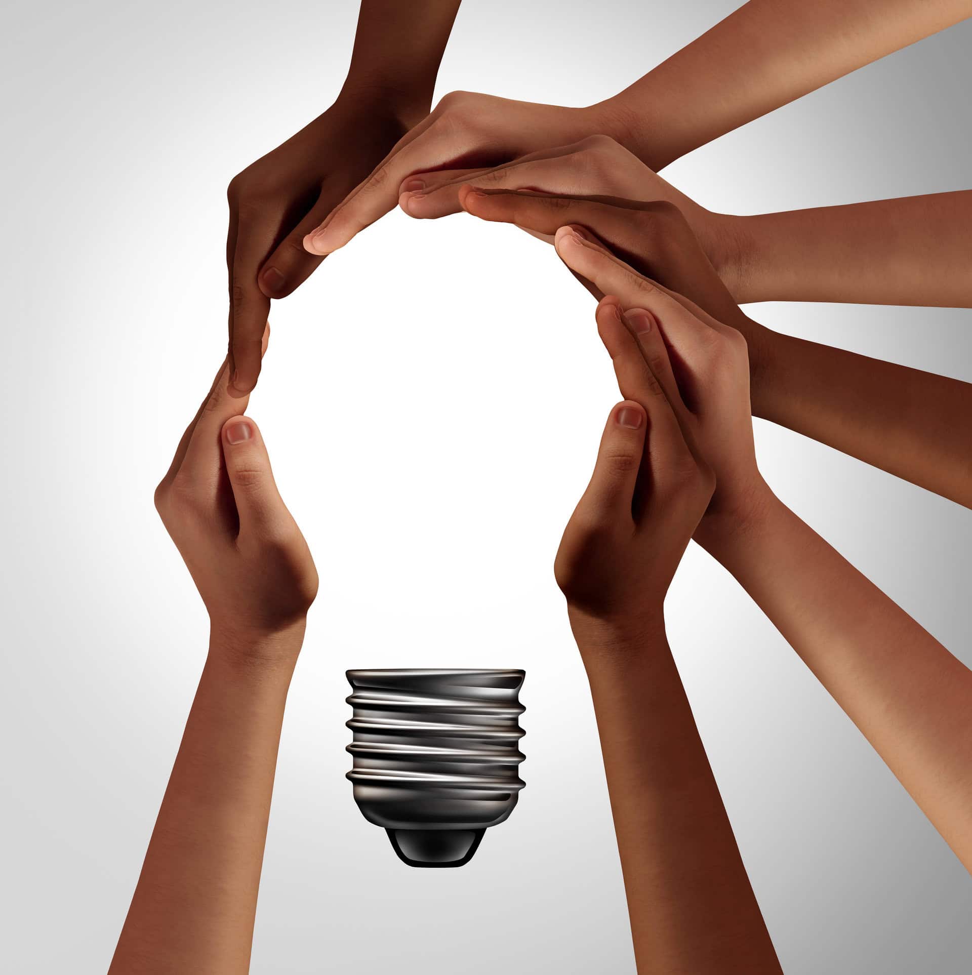Team thinking together as a diverse group of people coming together joining hands into the shape of an inspirational light bulb as a community support metaphor with 3D elements.