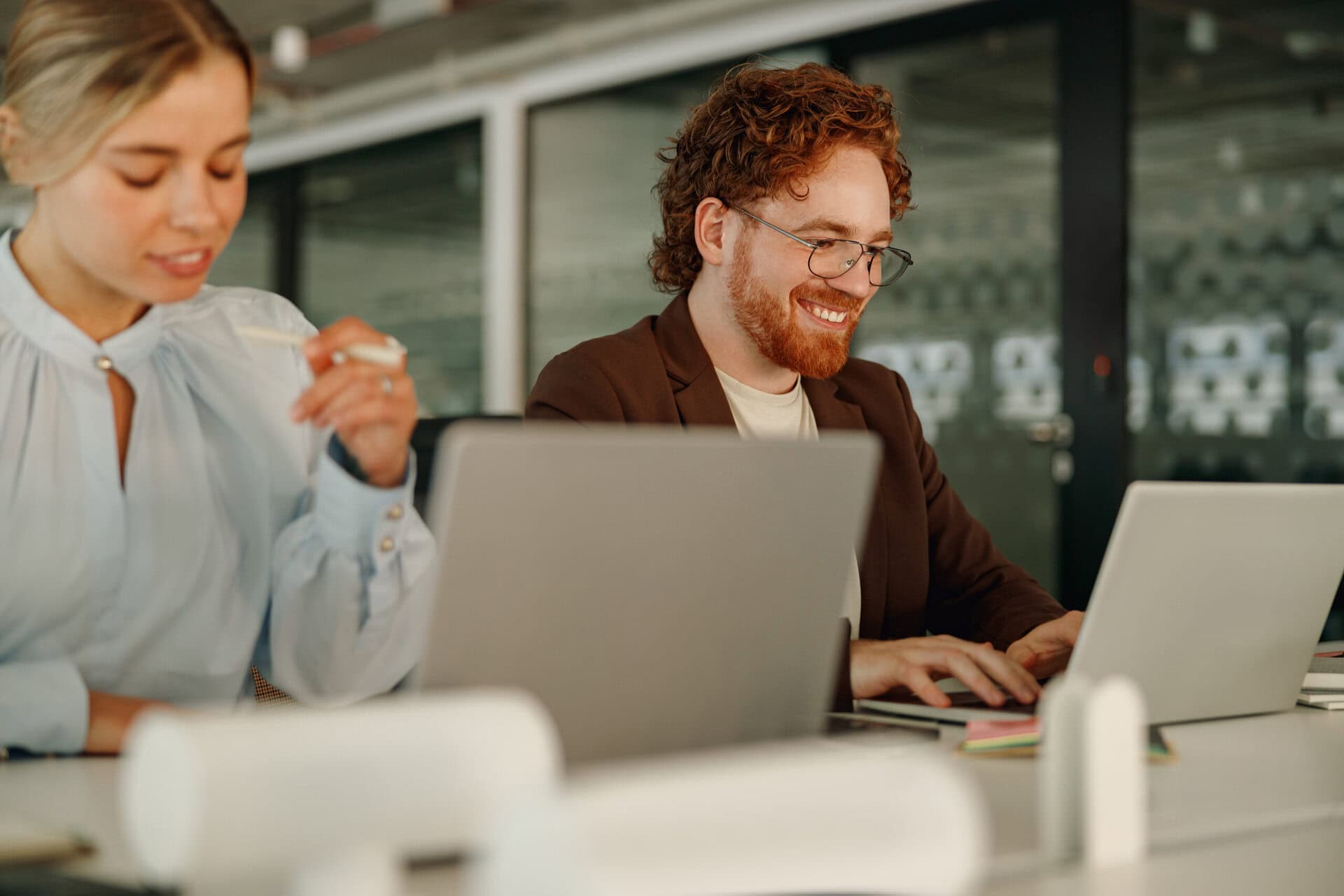 Two dedicated professionals are engaged in a highly productive and innovative collaboration at a sleek office workspace